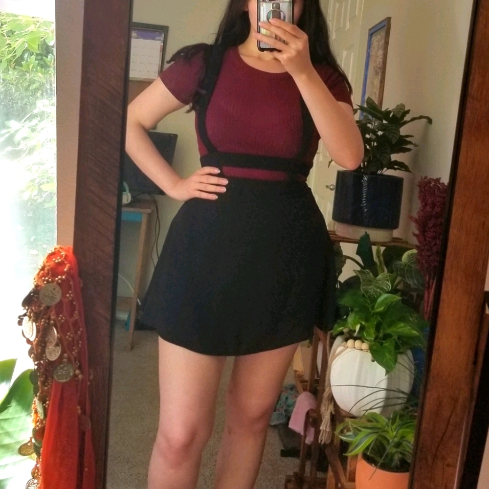 Black skirt with suspenders.